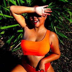 Casually dressed model in red bikini with tattoo on foot