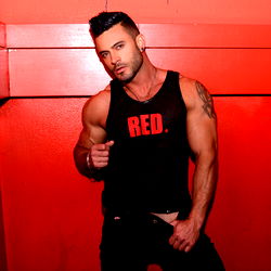 Fitness Model Andy Star in Energetic Red Photo Backdrop
