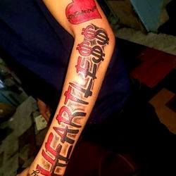 Tattoo Artist's Arm with Heart and Money Tattoos