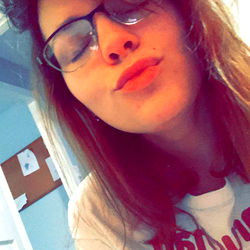 A young woman in a room, capturing her thoughts and the world around her from Chattanooga.