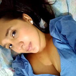 Female Model in Blue Top Lying Down with Phone