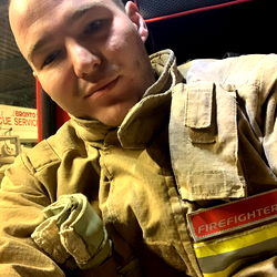 Firefighter with a beard taking a selfie