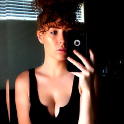 Beautiful Woman in Black Tank Top Taking a Mirror Selfie