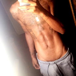 Fitness enthusiast Astro in casual attire, showcasing a home gym setup