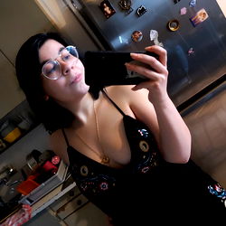 A Woman Taking a Mirror Selfie in the Kitchen