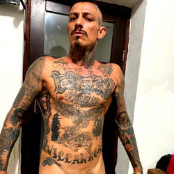 Greek Tattoo Model Showcasing Ink and Style