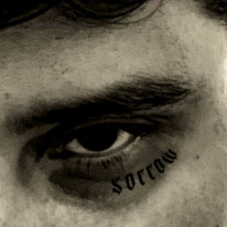 Artistic Black and White Portrait of a Man with Tattoos and Piercings