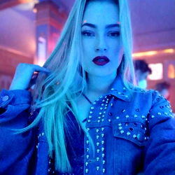 Model in Denim Jacket and Ponytail on Blue Stage