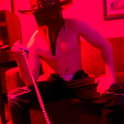 Plague_Daddy in a Shirt and Hat Sitting On Couch