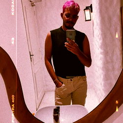 Trendy Fashion Model with Pink Hair, Standing in a Mirror