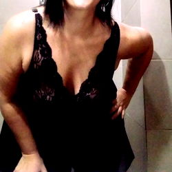 A Woman Smiling in a Bathroom Mirror