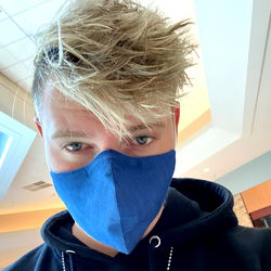 Kyi, an OnlyFans Model, Showcases Fashionable Blue Mask and Striking Blonde Hair