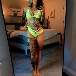 Tattooed Model Showcasing Her Tattoos in a Yellow Bikini