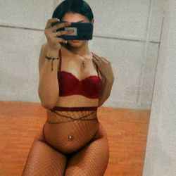 Emily the OnlyFans Model Posing in a Red Fishnet Bra