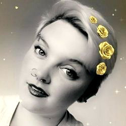 Fashion-forward individual with gold floral hair accessory, posing for OnlyFans