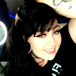 A confident and joyful woman posing for the camera, with a hint of rebellion.