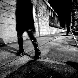 Model Walking on Sidewalk at Night