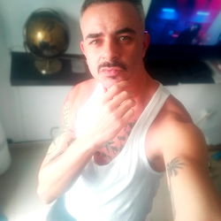 Stylish Man with Mustache and Tattoo, Posing in Living Room