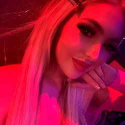 Kate, An OnlyFans Model from Houston TX, Posing in Vivid Red Light