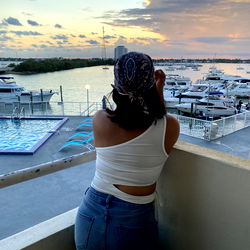 A person taking a photo with the ocean in the background