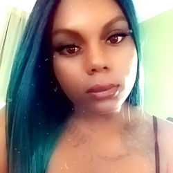 Cherokee26, an OnlyFans model with striking blue hair and captivating gaze, showcasing her vibrant style.