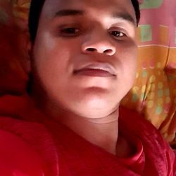 A young man taking a selfie from his bed in Bogota, Colombia