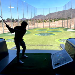 Golf Enthusiast in Practice Cage
