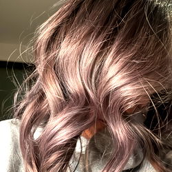 A stylish woman showcasing her long hair with subtle waves, paired with a casual purple shirt and cozy sweater. The photo captures the essence of Amethyst 💜💎's fashion sense.