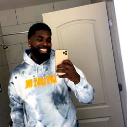 Smiling Guy in Colorful Hoodie Taking Selfie