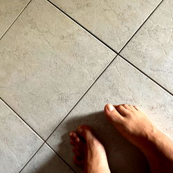 Feet on a Tiled Floor