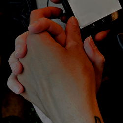 Hand holding cell phone, strong emotional connection depicted