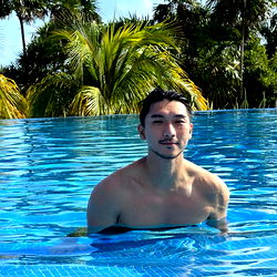 Max in a luxurious pool setting,