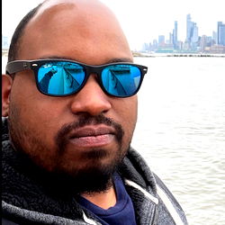 Man in Sunglasses Standing on Shore