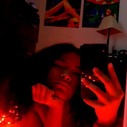 Glamourous Person in Red-Tinted Room with Reflective Surface