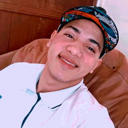 Smiling Individual Sitting on Couch