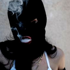 A person in a balaclava holding a cigarette