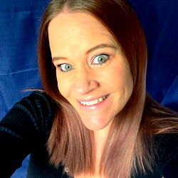 Auburn-haired woman with a smile in a casual setting