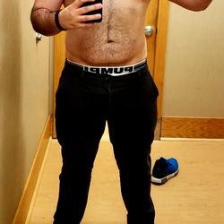 Shirtless Man in Shoe Store with Camera