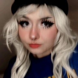 A Woman with Blonde Hair and White Pants, Posing for a Picture