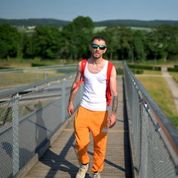 A Man Walking on a Bridge