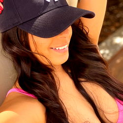 AmDias lounging in a vibrant bikini