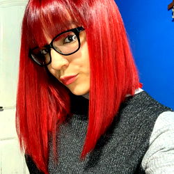 Female with Red Hair and Glasses Posing