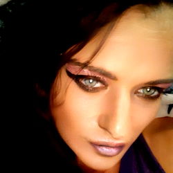 Blonde woman with dramatic eye makeup and purple lipstick, posing for OnlyFans