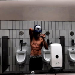 Fit Model in Bathroom Mirror with Muscles on Display