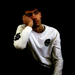 Contemplative Young Man in White Shirt and Long Sleeve