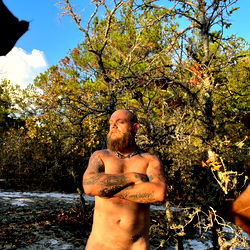 Bearded Man in Tattoos with Piercing Standing Outdoors