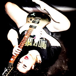 Alice Renae's Playful Pose with Guitar