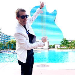 Adamo Brasil in front of a Gibson Guitar Sculpture