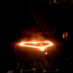Lively Outdoor Celebration with a Flaming Heart Shape