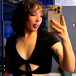 AmberBaby: A Seductive Model in a Tight Outfit, Taking a Selfie